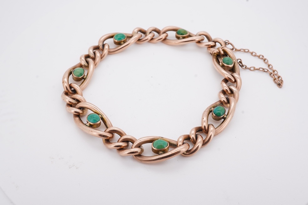 An early 20th century yellow metal (stamped 9c) and seven stone cabochon turquoise set curb link bracelet, 19cm, gross weight 14 grams. Condition - poor to fair
